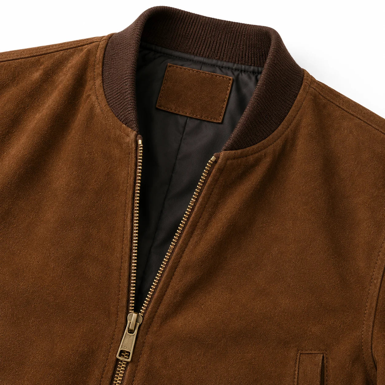 Close-up of suede nap texture and YKK brass zipper on bomber jacket