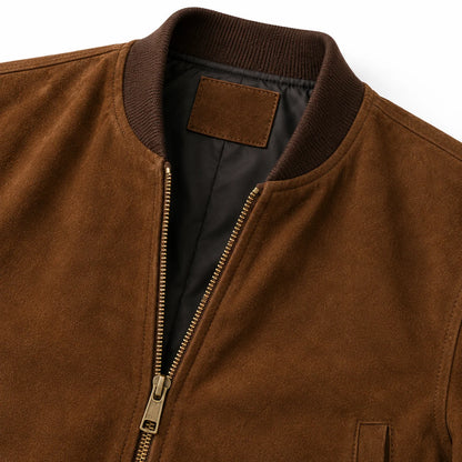 Close-up of suede nap texture and YKK brass zipper on bomber jacket