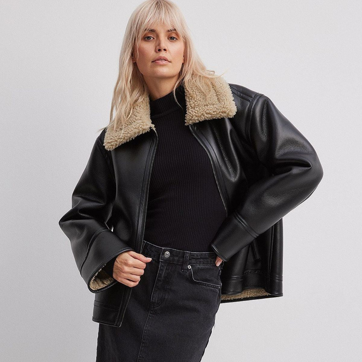 Black leather oversized aviator jacket with genuine tan shearling collar and lining, women's, front view