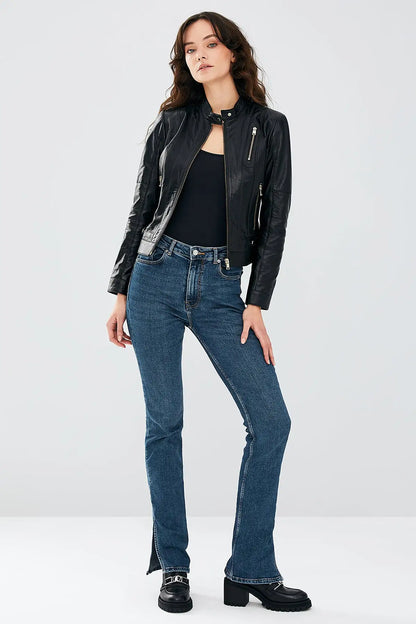 Woman wearing black stretch-fit leather biker jacket with jeans, casual styling