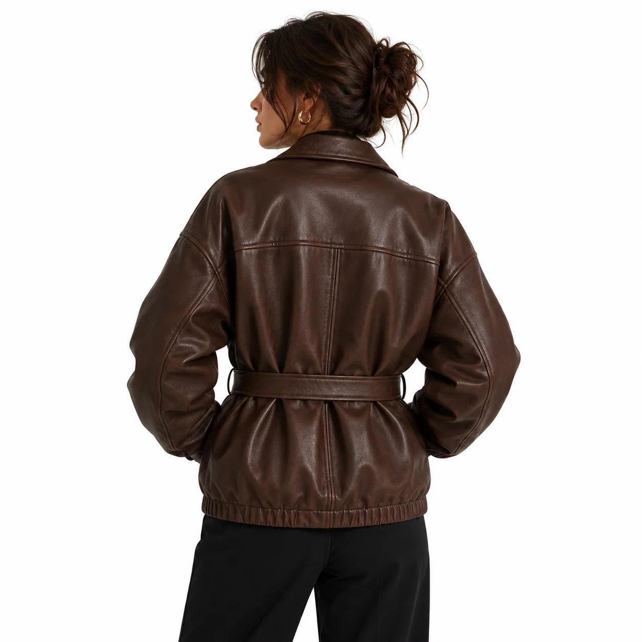 Woman wearing oversized brown leather jacket belted at the waist, styled with black turtleneck, back look