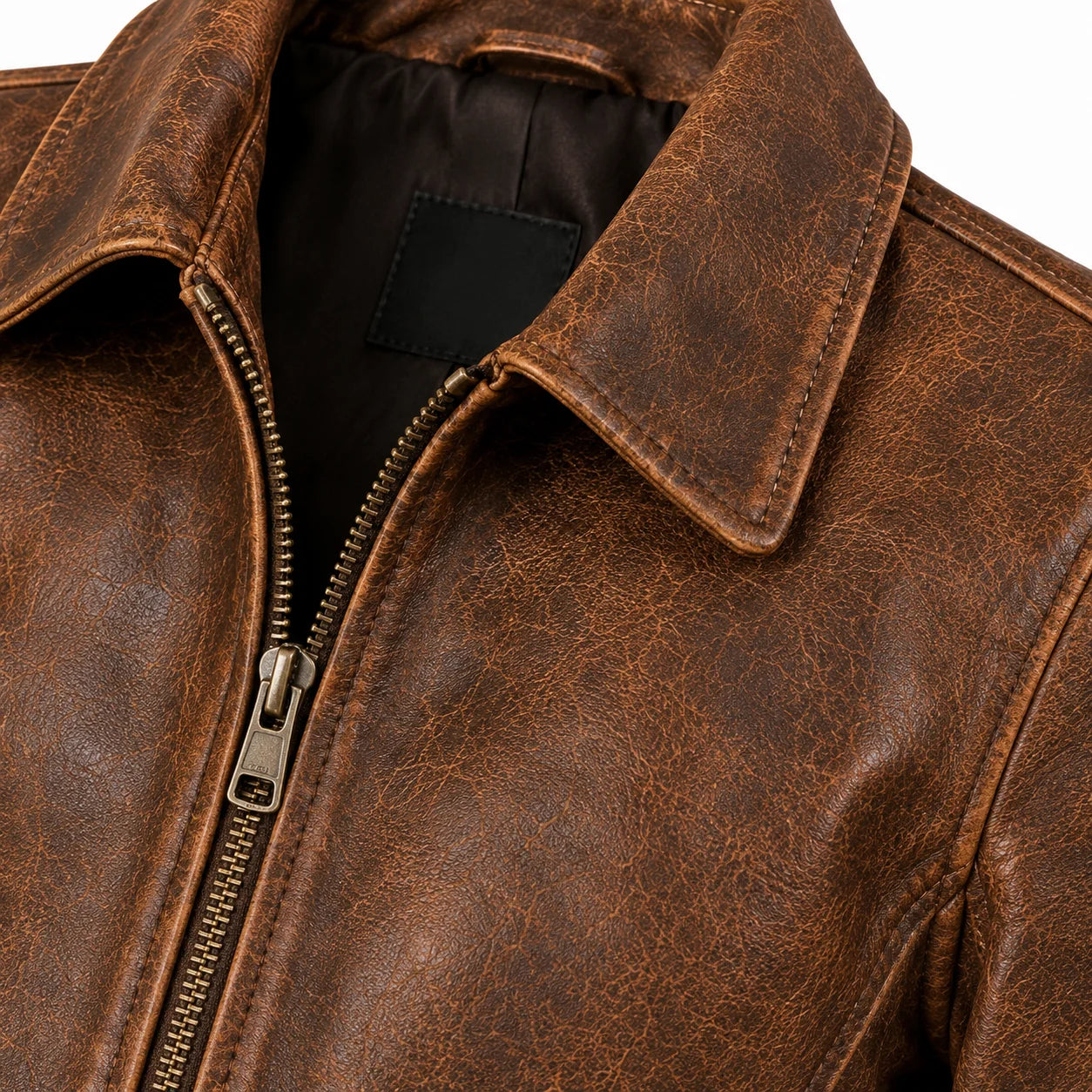 Close-up of light natural distressing and vegetable-tan cowhide grain, women's vintage jacket