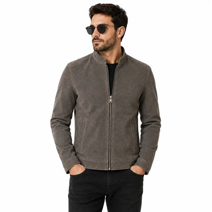 Man wearing suede cafe racer jacket with black jeans and boots, street style