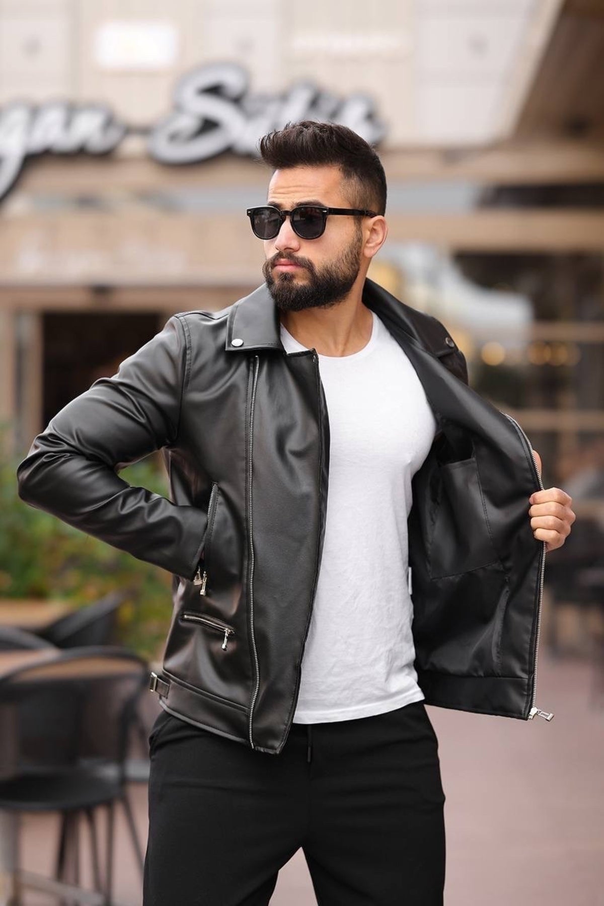 Man walking in black asymmetric zipper motorcycle leather jacket, full front view