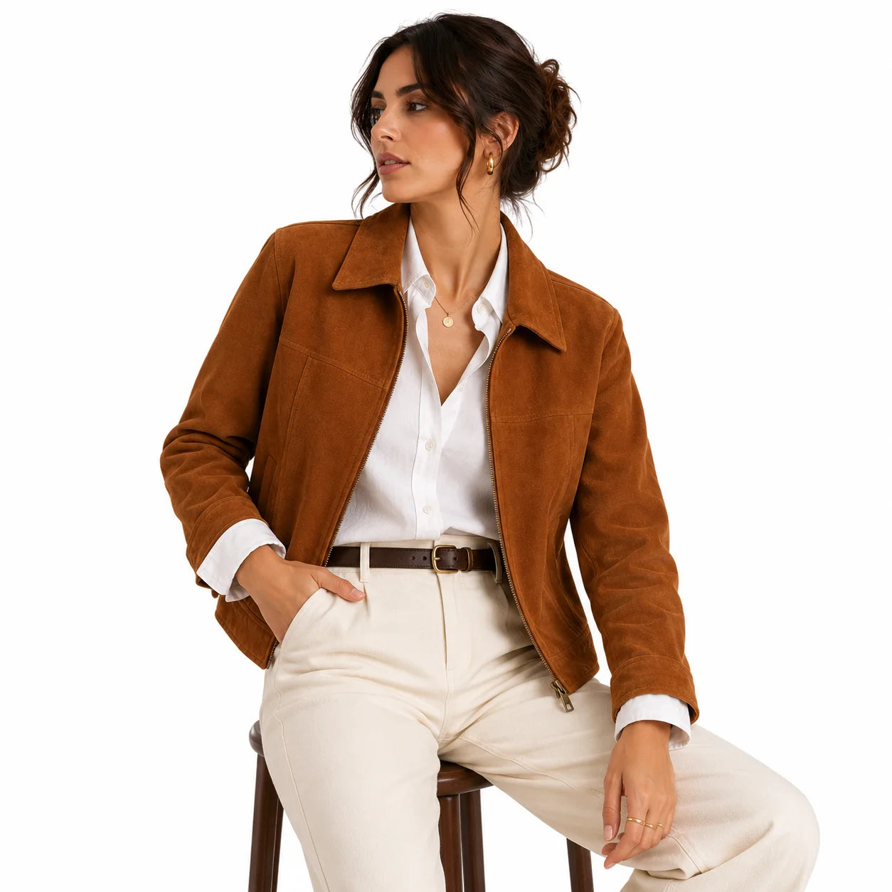 Woman wearing caramel suede structured leather jacket with white shirt and cream trousers