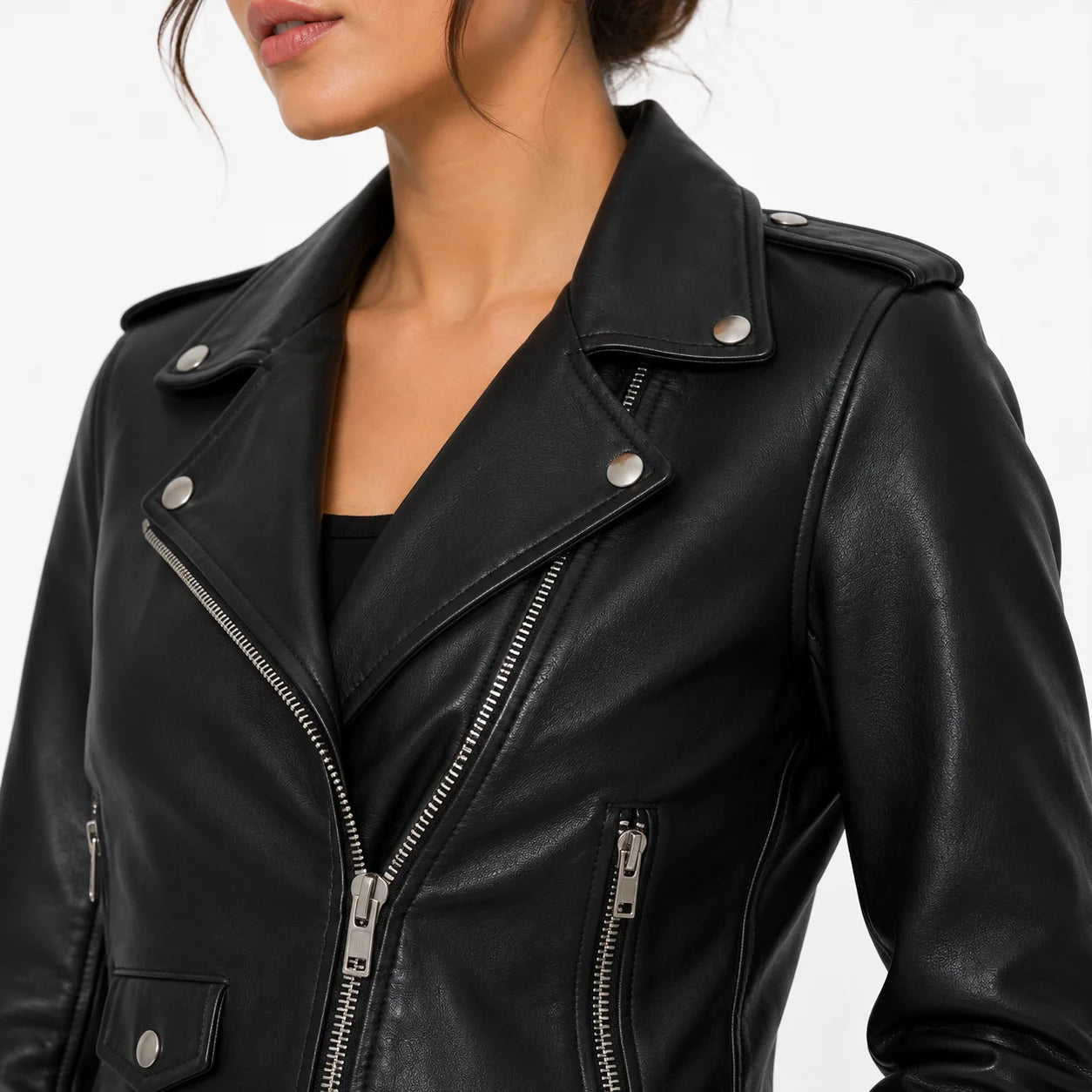 Close-up of a women's black celebrity inspired leather biker jacket showing premium leather texture, lapels, and silver zipper details.